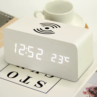 A wooden LED digital desk alarm clocks featuring Qi wireless charging pads built into their top surfaces