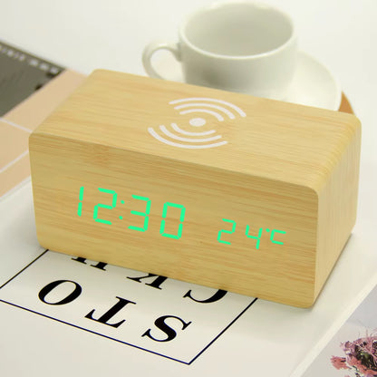 A wooden LED digital desk alarm clocks featuring Qi wireless charging pads built into their top surfaces