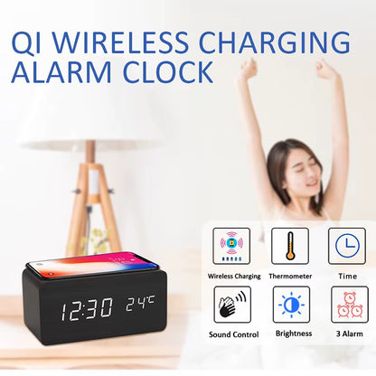 A wooden LED digital desk alarm clocks featuring Qi wireless charging pads built into their top surfaces